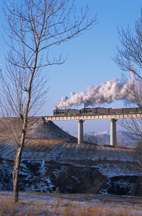 Two QJ-class Jitong Railway steam locomotives haul eastbound freight west of Hadashan, Inner Mongolia, China, on November 23, 2003. Photograph by Katherine Botkin. BOTKINK-103-KT-163,© 2003, Katherine Botkin.