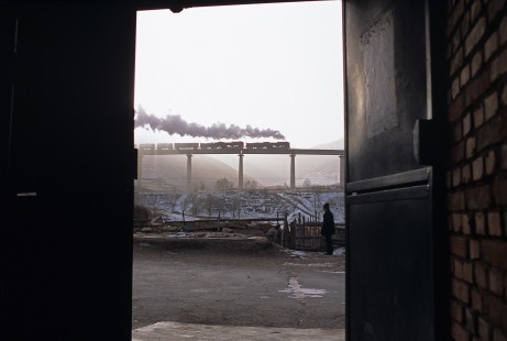 Jitong Railway QJ-class steam locomotive nos. 7040 and 6828 haul freight over viaduct west of Hadashan, Inner Mongolia, China, on December 9, 2004. Photograph by Katherine Botkin. BOTKINK-103-KT-206, © 2004, Katherine Botkin.