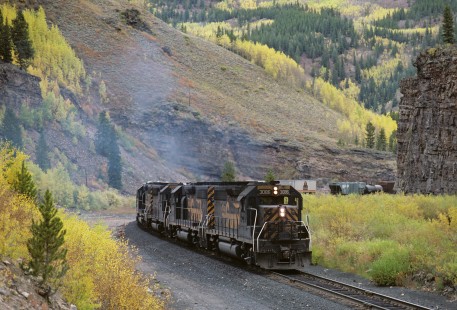 Three Denver and Rio Grande Western Railroad diesel locomotives, led by  no. 3086, haul freight train over Tennessee Pass at Pando, Colorado, on September 22, 1986. Photograph by Katherine Botkin, BOTKINK-8-KT-122, © 1986, Katherine Botkin.
