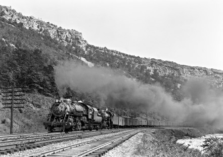Baltimore and Ohio Railroad 2-8-2 steam locomotive no. 4469 and 4-6-2 steam locomotive no. 5035 with a 15-car express train westbound in the Narrows of Cumberland, Maryland, on April 9, 1948.  Photograph by Donald W. Furler, Furler-13-075-02, © 2017, Center for Railroad Photography and Art