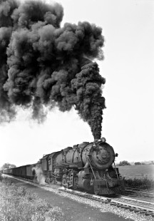 Baltimore and Ohio Railroad 2-10-2 steam locomotive no. 6107 hauls freight east on the Western Maryland Railway, exercising trackage right privilege, at Williamsport, Maryland, on September 2, 1941. The photographer noted this was a heavy train coming up the grade at an exceedingly slow rate of speed, assisted by Western Maryland pusher locomotives. Photographed by Donald W. Furler, Furler-13-109-01, © 2017, Center for Railroad Photography and Art