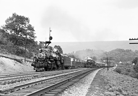 Baltimore and Ohio Railroad passenger train no. 9 overtaking a westbound freight train at Hyndman, Pennsylvania, on August 6, 1953. The passenger train has 4-6-2 steam locomotive no. 5083 as a head-end helper to assist its Electro-Motive diesels. Photograph by Donald W. Furler, Furler-13-091-02, © 2017, Center for Railroad Photography and Art