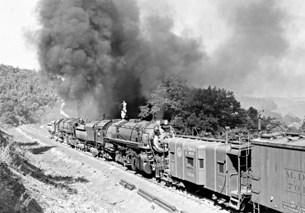 Baltimore and Ohio Railroad 2-10-2 steam locomotive nos. 6161 and 6127 pushing a 97-car freight train west at Manila, a railroad location in Meyersdale, Pennsylvania, on September 3, 1949. Engines on head end were no. 6195 and no. 6188.  Photographed by Donald W. Furler, Furler-14-002-01, © 2017, Center for Railroad Photography and Art