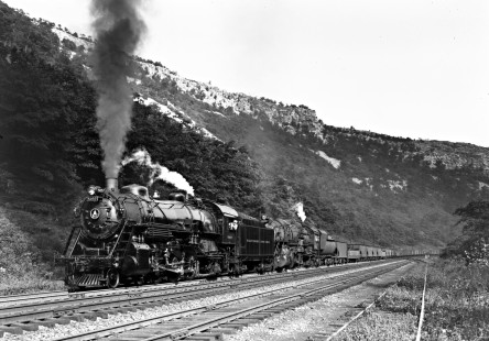 Baltimore and Ohio Railroad 4-6-2 steam locomotive no. 5057 and 2-10-2 steam locomotive no. 6195 leading a 100-car freight train west through The Narrows of Cumberland, Maryland, on September 3, 1949. Photograph by Donald W. Furler, Furler-13-086-02, © 2017, Center for Railroad Photography and Art