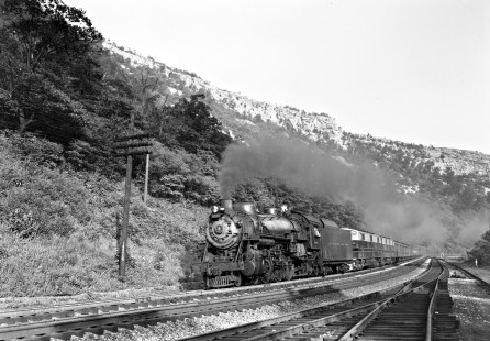 Baltimore and Ohio Railroad 4-6-2 steam locomotive no. 5048 and diesel locomotive no. 61 leading 11-car passenger train no. 9 through the Narrows of Cumberland, Maryland, on September 6, 1952.  Photograph by Donald W. Furler, Furler-13-083-01, © 2017, Center for Railroad Photography and Art