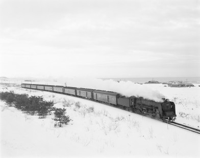 Japanese National Railways steam locomotive no. C62-3 pulling express train #104 South running from Sapporo to Hakodate on Hakodate main line at Yakumo, Hokkaido, Japan, on January 16, 1971. Photograph by Victor Hand, Hand-JNR-18-024.JPG