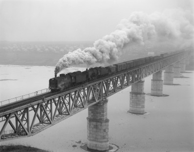 Soviet Railways steam locomotives SO-4371 and SO-3146 hauling a mixed train south from Gretchany to Larga crossing the Dniester River in Ukraine on February 22, 1994. Photograph by Victor Hand, Hand-SZD-260-040