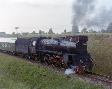 Polish State Railways steam locomotive OL49-85 leading a passenger train at Ograszka, Republic of Poland, on June 3, 1990. Photograph by Victor Hand, Hand-PKP-SZD-VR-C251-05