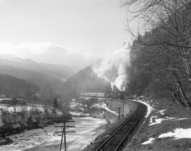 Soviet Railways steam locomotives YEA-2026 and EM735-72 haul a passenger excursion train north running from Rakhov to Delyatin along the Prut River at Mykulychyn, Ukraine, on February 28, 2004. Photograph by Victor Hand, Hand-SZD-270-72