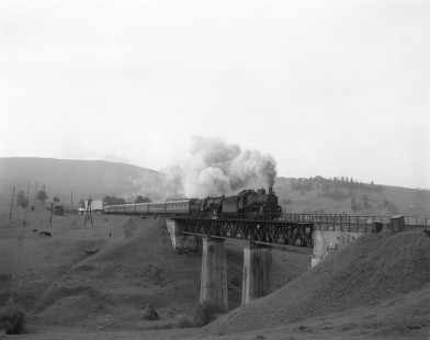 Soviet Railways steam locomotives E-770-99 and TE-5653 lead a northbound passenger excursion across a trestle at Lazeshchyna, Ukraine, on a run from Rachov to Kolomiya on September 28, 1994. Photograph by Victor Hand, Hand-SZD-260-164