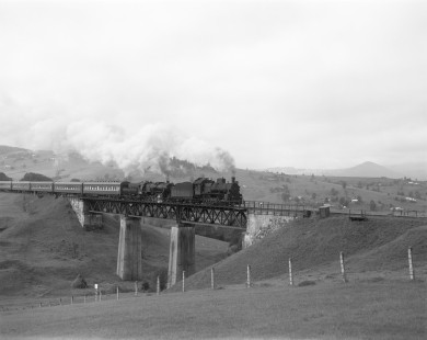 Soviet Railways steam locomotives E-770-99 and TE-5653 lead a northbound passenger excursion across a trestle at Lazeshchyna, Ukraine, on a run from Rachov to Kolomiya on September 28, 1994. Photograph by Victor Hand, Hand-SZD-260-163