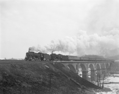 Soviet Railways steam locomotives L-5141 and L-5008 pull a passenger excursion train south from to Korosten to Shepetowka across the Sluch River at Novohrad-Volynskyi, Zhytomyr, Ukraine, on February 21, 1994. Photograph by Victor Hand, Hand-SZD-260-027