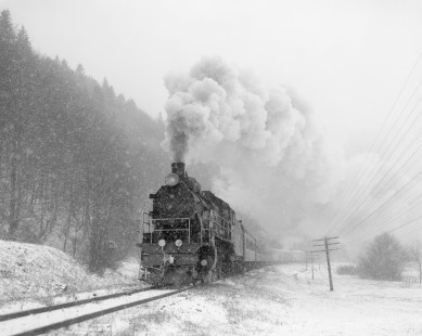 Soviet Railways steam locomotive SU251-86 leading a passenger excursion train south from Ivano Frankovsk to Rachov through the snow at Matarov, Ukraine, on December 10, 1992. Photograph by Victor Hand, Hand-SZD-254-292