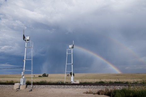 Semaphores on BNSF's "Raton Line" in northeastern New Mexico as a thunderstorm generated rainbows to the east, on September 8, 2019. © Tom Taylor
