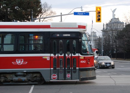 The sun is setting on December 28, 2019 as iconic TTC 4042 and a few of her sisters complete thirty years on Toronto’s streets on the last day of revenue service for the CLRVs (Canadian Light Rail Vehicles) seen here passing the Princes’ Gates of the Canadian National Exhibition. © Richard McQuade