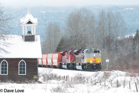 Now in regular service, Canadian Pacific heritage unit no. 7016 leads a unit train of potash as it climbs Notch Hill, British Columbia, passing the landmark abandoned church on December 29, 2019. © Dave Love