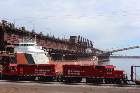 Two Canadian Pacific diesels pull a mixed freight train through the CN taconite loading facility in Duluth, Minnesota, on April 20, 2019. © Bruce Loppnow