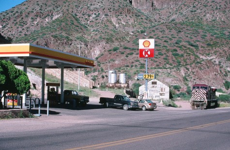 An Arizona Eastern SD90/43MAC parked at a Circle K Shell station in Clifton, Arizona, on September 5, 2010. With literally no track in front of the engine, it appears the crew pulled up for a fill up at the gas station. More likely, the crew went in for some cold drinks and a snack and got as close as they could. © Bon French