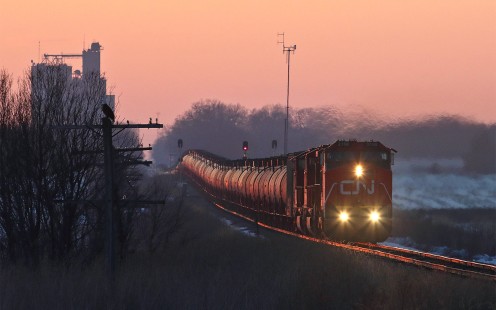 CN Eastbound Train U70691-09 travels east out Jesup, Iowa, passing a bald eagle perched on a code line pole, on February 10, 2020. © Craig Williams