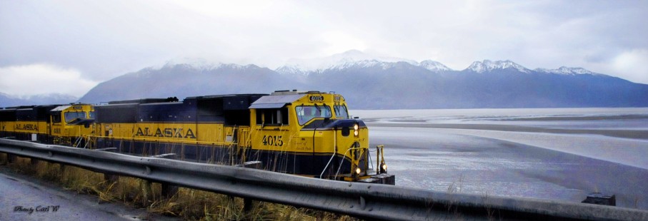 Alaska Railroad no. 4015 pulls loaded freight coming out of the Port of Whittier, Alaska, and "Spirit of North Pole" leads no. 4008 up the the Turnagain Arm on its way into Anchorage. © Carl Wassink