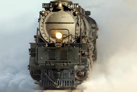 Enveloped in an awe-inspiring spectacle of steam, Union Pacific Big Boy 4014 departs Boone, Iowa in a dramatic display of brute power, on July 16, 2019. After an overnight stay, 4014 is on its second day (July 16) of the 2019 Great Race Across the Midwest Tour. The locomotive and its nine-car consist will travel 22 miles east on former Chicago and North Western's double-track main line to Nevada Junction. © Stewart Buck