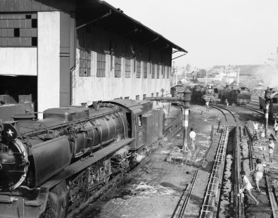 Children amuse themselves at an engine shop in Jatinegara, Java, Indonesia, on September 22, 1971. To the left Perusahaan Jawatan Kereta Api (PJKA) steam locomotive no. D52-031, which is still wearing the paint of its predecessor Perusahaan Negara Kereta Api (PNKA), gets a wash. Photograph by Victor Hand, Hand-PNKA-22-218