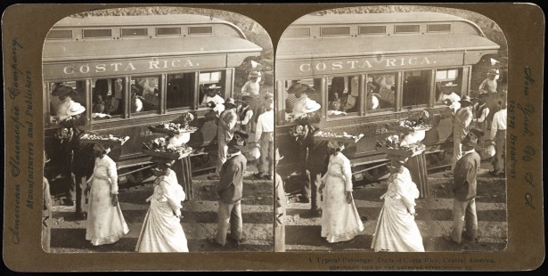 "A typical passenger train of Costa Rica, Central America, c. 1904." A stereograph view of a passenger car stopped while female vendors approach with trays, filled with goods, balanced on their heads. Created and copyright by the American Stereoscopic Company. Library of Congress Prints and Photographs Division, LC-USZ62-128703