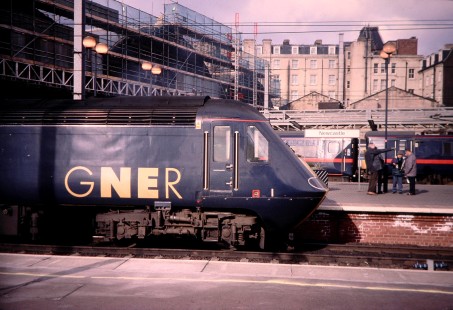 A group of friends laugh on a platform between two Great North Eastern Railway (GNER) HST commuter trains at Newcastle station, on March 1, 2000. Photograph by Fred Springer. © 2020, Center for Railroad Photography and Art, Springer-UK-NZ-CO-05-22