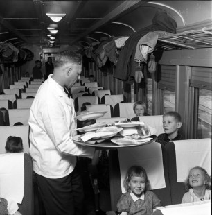 A school class from Hopkins, Minnesota receives lunch onboard a Soo Line Railroad passenger train while touring the Shoreham Shops in Minneapolis, in November 1959. Photograph by Wallace Abbey. © 2020, Center for Railroad Photography and Art, Abbey-04-130-05