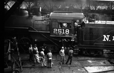 Workers gather around National Railways of Mexico (N de M) steam locomotive no. 2518 inside an engine house in Acambaro, Mexico, on August 30, 1960. Photograph by Ted Rose. © 2020, Center for Railroad Photography and Art, Rose-01-125-002