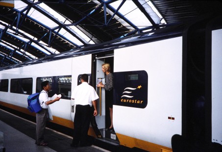 The crew of a Eurostar high-speed rail service stops to help a tourist with directions, in London, England, on August 15, 1998. Photograph by Fred Springer. © 2020, Center for Railroad Photography and Art, Springer-Swiss(1)-01-24