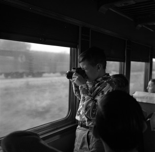An aspiring railfan practices his photography on a National Railway Historical Society fan trip from Milwaukee to Green Bay, Wisconsin, on May 25, 1952. Photograph by Wallace Abbey. © 2020, Center for Railroad Photography and Art, Abbey-01-149-01