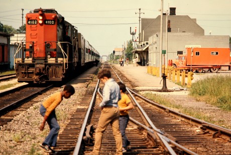 During a time before stricter rules were enforced, kids play on the tracks at Chatham station in Chatham, Ontario as Canadian National Railway (CN) diesel locomotive no. 4102 prepares to pull away, in June 1974. Photograph by John F. Bjorklund. © 2020, Center for Railroad Photography and Art, Bjorklund-19-28-17