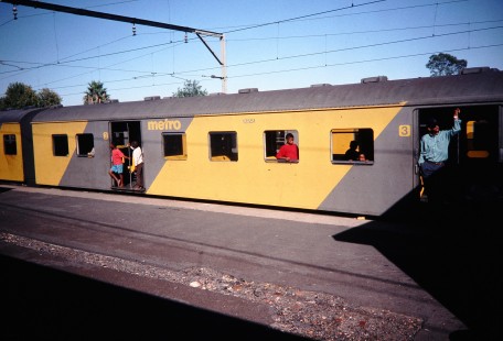 Passengers peek out of a Metrorail Western Cape car stopped at a platform in Paarl, Western Cape, South Africa, on April 2, 1995. Photograph by Fred Springer. © 2020, Center for Railroad Photography and Art, Springer-So.Africa-NOR-SWE-06-19
