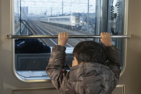 A young railfan enjoys the view from the front of a suburban train in Kyoto, Japan, on January 2, 2007. © Scott Lothes
