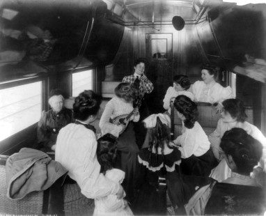 "A tourist sleeper [car] musical, c. 1905." A woman plays a mandolin for her fellow female passengers. Photograph by George R. Lawrence Co. © George T. Nicholson. Library of Congress Prints and Photographs Division, LC-USZ62-29465
