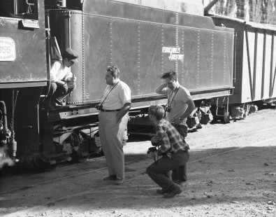An Argentine railfan, Charlie Lewis, and Roger Spotswood talk to the engineer of General Manuel Belgrano Railway (FCGB) steam locomotive no. 1355, in Tilcara, Argentina, on September 24, 1972. Photograph by Victor Hand, Hand-FA-24-303