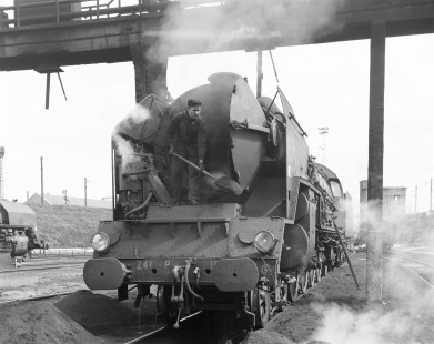 Worker cleaning the smokebox of French National Railways steam locomotive no. 241-P at Le Mans, Sarthe, France, on August 20, 1964. Photograph by Victor Hand, Hand-SNCF-05-316