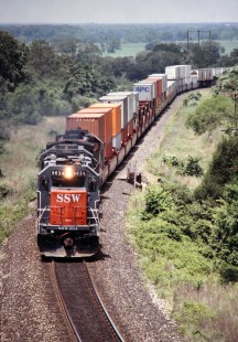 Westbound Southern Pacific Railroad stack train approaches West Point, Texas, in July of 1991. Photograph by J. Parker Lamb. Lamb-03-030-16.JPG; © 2016, Center for Railroad Photography and Art
