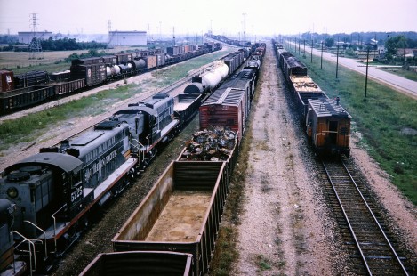 Two Southern Pacific Railroad hump cuts in Houston's Inglewood Yard. Westbound train heads to receiving yard in July of 1964. Photograph by J. Parker Lamb. Lamb-03-029-06.JPG; © 2016, Center for Railroad Photography and Art