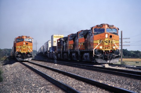 Burlington Northern and Santa Fe Railway intermodal trains arrive at Emporia, Kansas, junction around the same time, although the right one is on a fast track to the southwest in October of 2004. Lamb-03-035-13.JPG; © 2016, Center for Railroad Photography and Art