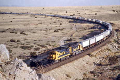 Eastbound Atchison, Topeka and Santa Fe Railway trailers on flatcars (TOFC) train enters Abo Canyon en route from Belen yard and Mountainair, New Mexcio, in May of 1991. Photograph by J. Parker Lamb. Lamb-03-034-16.JPG; © 2016, Center for Railroad Photography and Art