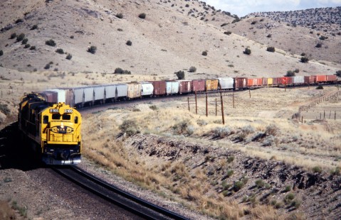 Westbound Atchison, Topeka and Santa Fe Railway manifest emerges from Abo Canyon en route to Belen, New Mexico terminal, in June of 1990. Photograph by J. Parker Lamb. Lamb-03-034-13.JPG; © 2016, Center for Railroad Photography and Art