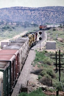 Eastbound Atchison, Topeka and Santa Fe Railway train enters Schoolie siding west of Mountainair, New Mexico, in July of 1991. Photograph by J. Parker Lamb. Lamb-03-034-02.JPG; © 2016, Center for Railroad Photography and Art