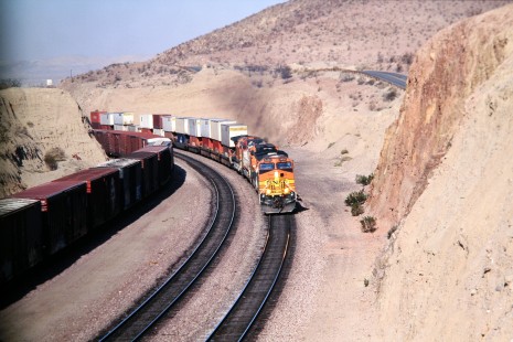 Burlington Northern and Santa Fe Railway locomotive no. 5450 with eastbound intermodal train departs from Barstow California, in November of 2002. Photograph by J. Parker Lamb. Lamb-03-047-05.JPG; © 2016, Center for Railroad Photography and Art