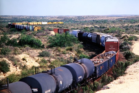 Eastbound Union Pacific Railroad train negotiates difficult terrain near Comstock, an unincorporated community in Val Verde, Texas, in April of 2003. Photograph by J. Parker Lamb. Lamb-03-041-02.JPG; © 2016, Center for Railroad Photography and Art