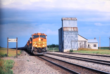 Burlington Northern and Santa Fe Railway no. 5102 with westbound grain train passes Wheelock siding in August of 2004. Photograph by J. Parker Lamb. Lamb-03-044-08.JPG; © 2016, Center for Railroad Photography and Art
