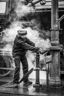A Harz Railway fireman opens a connection to give his iron colleague a drink in Drei Annen Hohne, Germany, on October 20, 2016. 

Read more about the 2020 John E. Gruber Creative Photography Awards Program: <a href="http://www.railphoto-art.org/connections-2020/" rel="noreferrer nofollow">www.railphoto-art.org/connections-2020/</a>