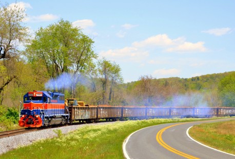 For several months, the Maryland Midland ran a unit dirt train between Westminster and New Windsor, Maryland. This was a flood control project, with the unit train designed to keep large dump trucks off of residential streets in each town. The train is seen here on May 13, 2020, along Avondale Road in Avondale, Carroll County, Maryland, with the MMID’s heritage unit GP38-3 2060 in the lead.

Warren Jenkins of Thurmont, Maryland writes that creative scheduling made it possible to continue his photography. “My state issued ‘stay at home’ orders by late March, restricting travel to local trips for groceries, banking, and other necessary supplies. This ended my weekly trips to the railroad museum. With the local shortline running one block from my apartment, I quickly found I could coordinate my trips for necessities with the passages of my local shortline. A scanner and my camera bag therefore became a part of every local errand trip.” Jenkins adds that “although the season of Covid has been personally frustrating, because of unemployment and separation from distant family members, pursuing the local shortline photographically has been very exciting and fulfilling.”

To see additional member work made during the Covid-19 pandemic, see “Creativity & Covid” in the <a href="http://www.railphoto-art.org/railroad-heritage-62/" rel="noreferrer nofollow">Fall 2020 issue of <i>Railroad Heritage</i></a>.
