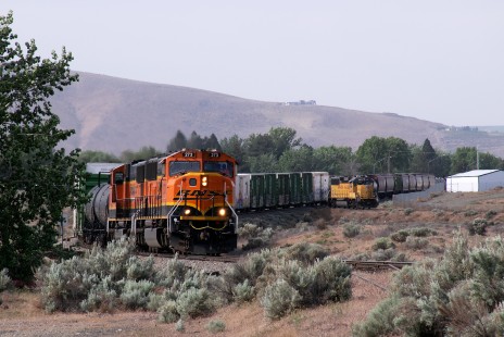 On May 11th, 2020, a Union Pacific crew has gone “in the hole” on a spur at Richland, Washington, allowing a long BNSF train to pass. 

Thomas Hillebrant of Richland, Washington, spent some of his pandemic photographing his hometown rails. Living just “two blocks from an active industrial lead,” Hillebrant has “photographed trains on this line countless times before, but working from home during the COVID-19 pandemic has given me even more opportunities to record their movements. Many days, a pressing project, team meeting, or deadline keeps me tightly bound to my computer, but an equal number of times, I have slipped out the door with my camera upon hearing a horn blowing for a nearby grade crossing. Missing a few minutes of work has not been a problem - I can usually make up the time later in the day.”

To see additional member work made during the Covid-19 pandemic, see “Creativity & Covid” in the <a href="http://www.railphoto-art.org/railroad-heritage-62/" rel="noreferrer nofollow">Fall 2020 issue of <i>Railroad Heritage</i></a>.
